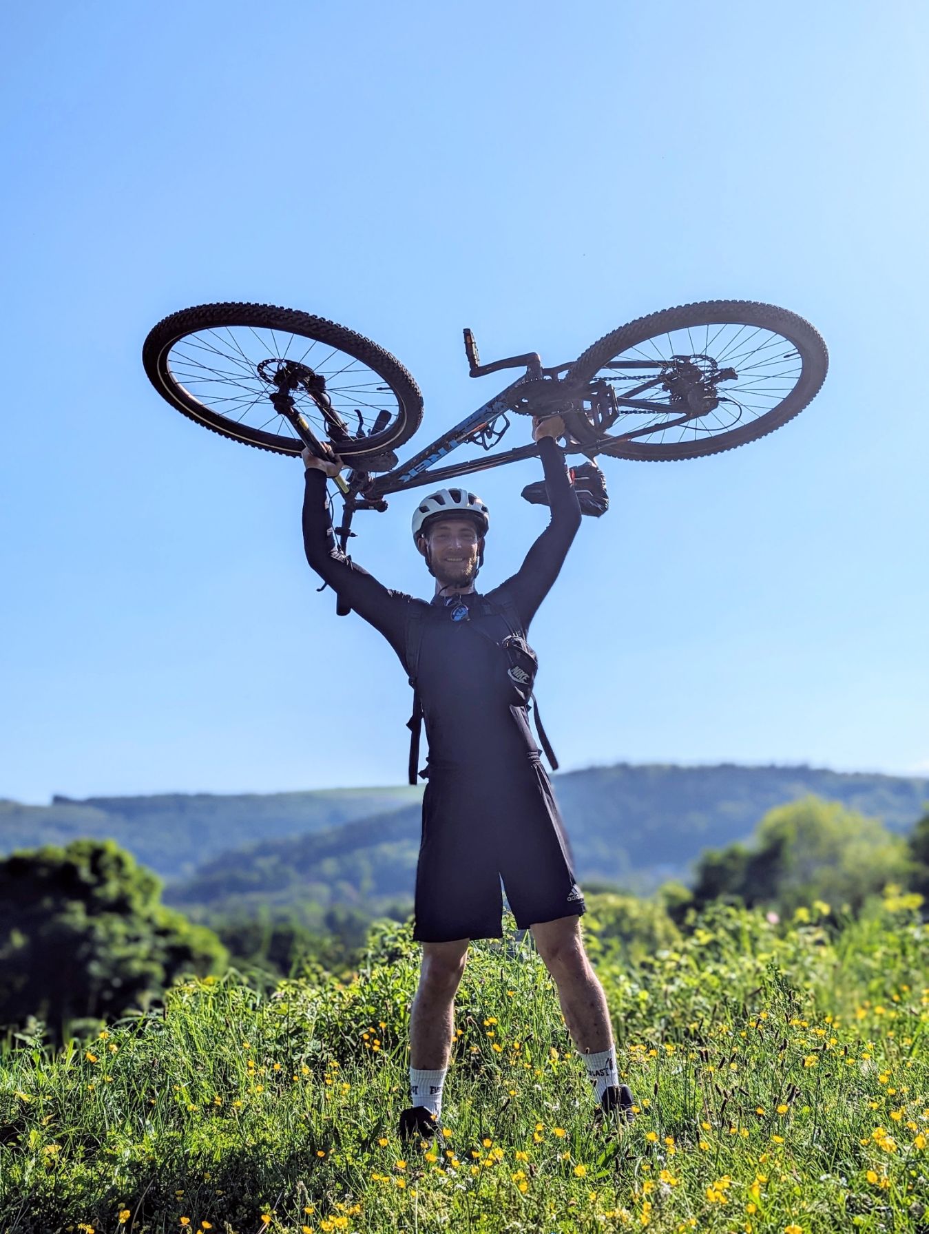 Ben Davies with mountain bike in the mountains